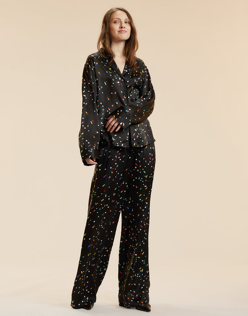 Black silk lounge pants in a pill print