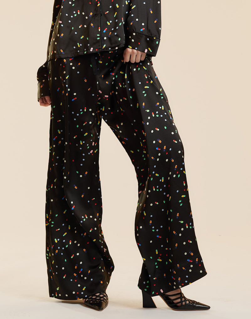 Black silk lounge pants in a pill print